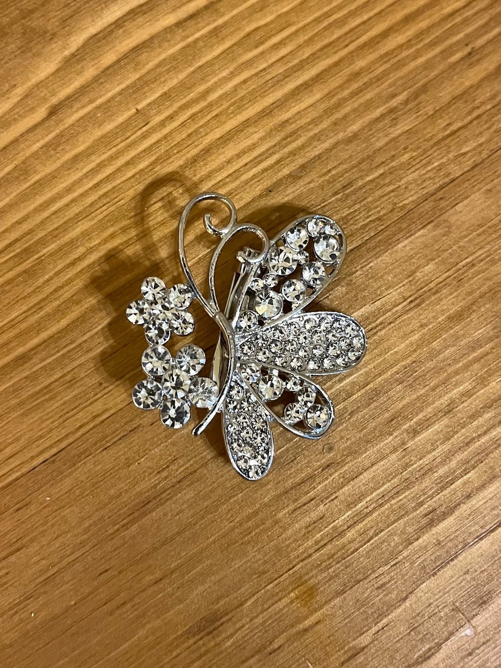Crystal butterfly & flower brooch on a silver tone back & fold under clasp 1 1/2